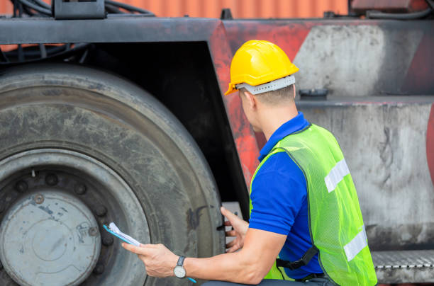 istock Mechanics checking wheel in cargo container. Professional technician pre-check forklift truck tires, safety concept. 1255856304