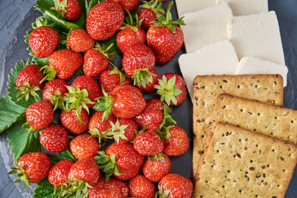 istock Sandwiches with fresh berries on a dark background, top view 1255857704