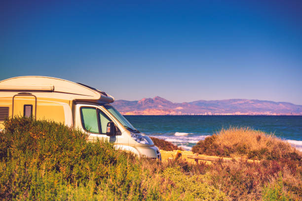 istock Camper car on beach, camping on nature 1255859313