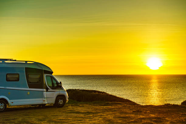 istock Camper car on beach at sunrise 1255859402