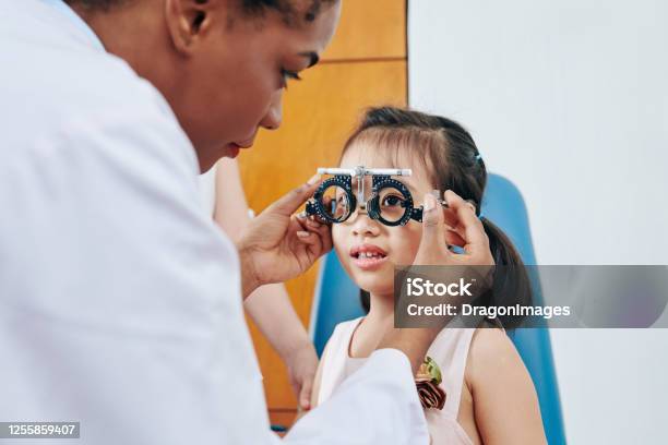 Girl Visiting Pediatric Optometrist Stock Photo - Download Image Now - Child, Eye Exam, Eyeglasses