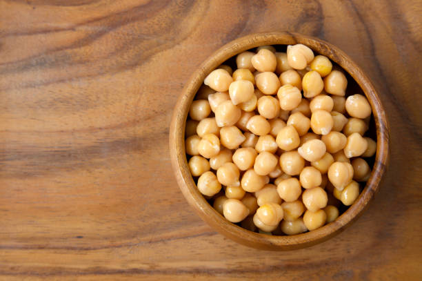 istock Boiled and  and drained chickpeas on a wooden background 1255861598