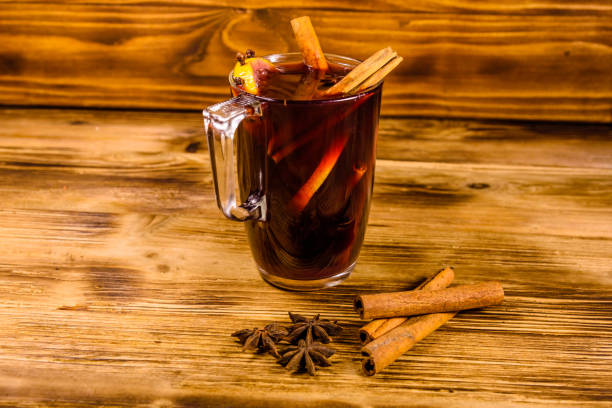 istock Cup of mulled wine with cinnamon on wooden table 1255863365