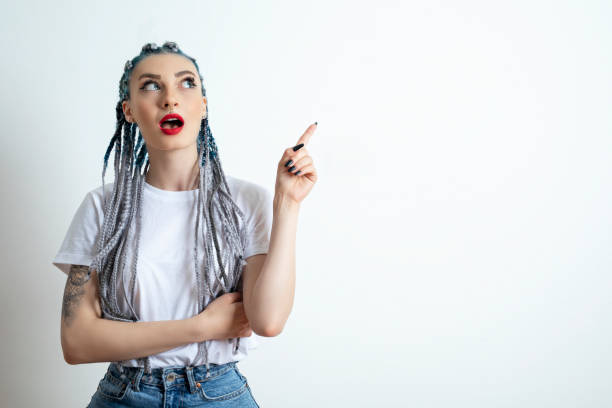 istock Young woman showing something 1255864688