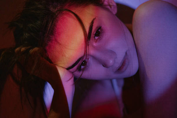 istock Young woman illuminated by the neon lights 1255864730