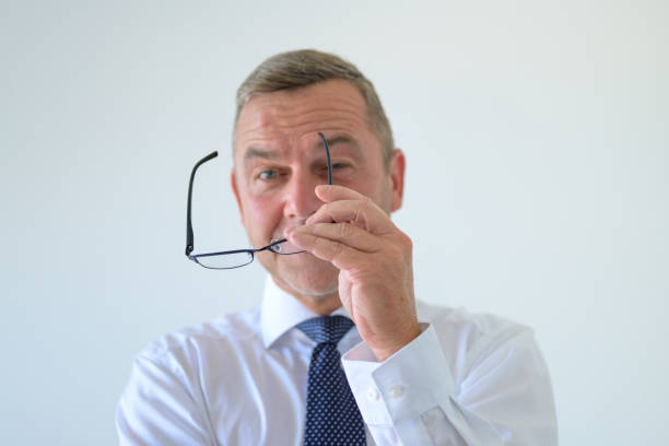 istock Businessman holding his spectacles in his hand 1255866553
