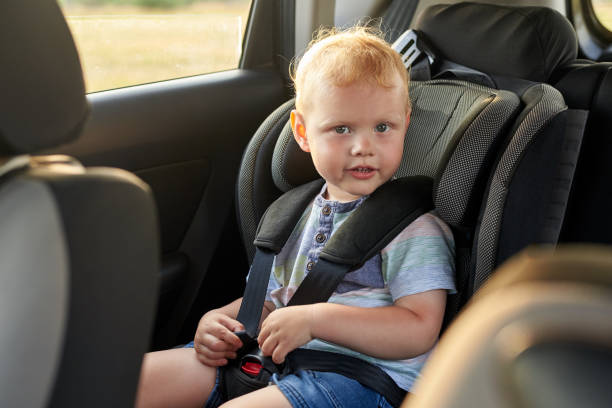 istock Happy little boy sits in a car seat. 1255874815