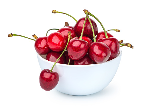 Cherries in bowl isolated on a white background