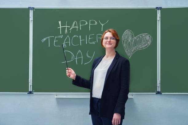 istock A smiling teacher shows with a pointer to the text 