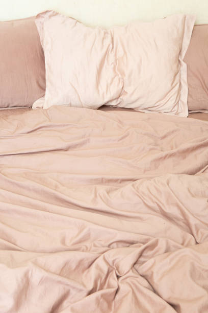 istock wrinkled sheet pillows blanket bed home textile 1255877856