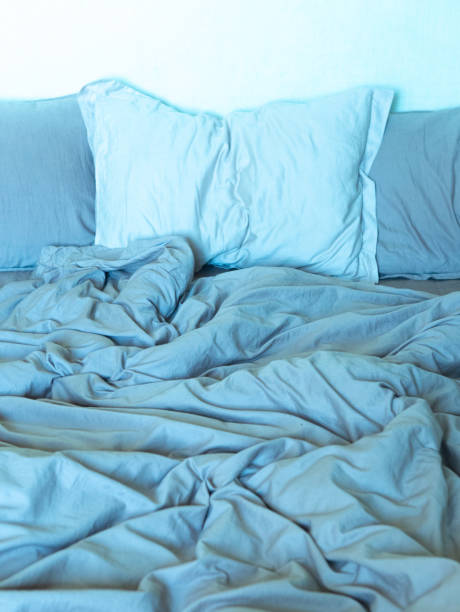 istock wrinkled sheet pillows blanket bed home textile 1255877861