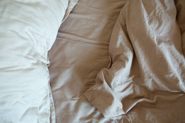 istock wrinkled sheet pillows blanket bed home textile 1255877867