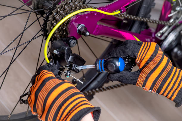 istock Mechanic serviceman repairman installing assembling or adjusting bicycle gear. 1255879138