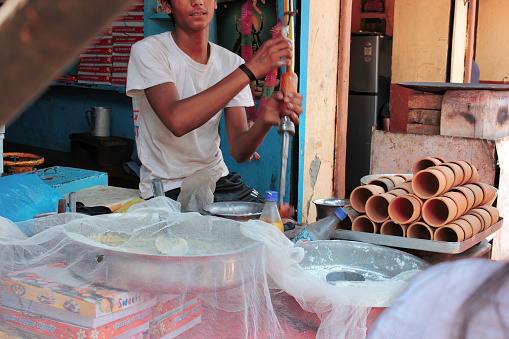 Mathura, India - May 11, 2012: A seller preparing lassi from yogurt in the city of Mathura city next to Krishna temple