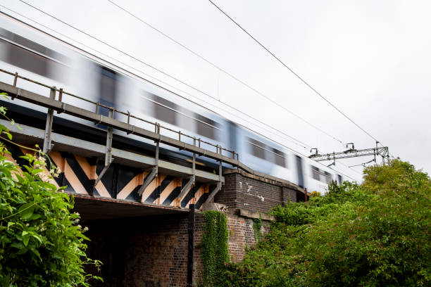 istock Fast train travelling over bridge in countryside with motion blur 1255879787