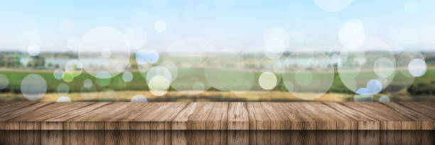 istock Empty of wood table top with blurred green tea. 1255881249