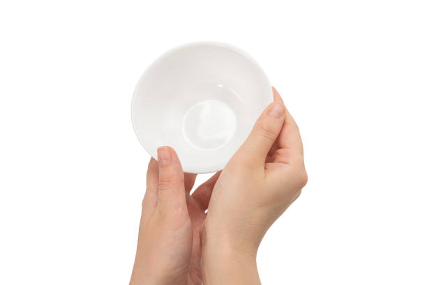 istock White bowl in woman hand isolated on white. 1255881293