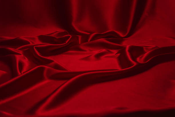 istock Red silk or satin luxury fabric texture can use as abstract background. 1255881312