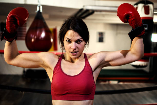 istock Fit female boxer training in a boxing hall 1255882682