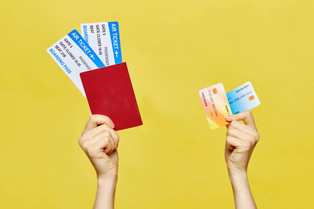 istock hands hold a passport with tickets and credit cards. 1255886147