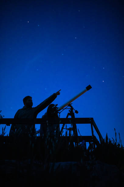 istock Father and daughter are watching stars 1255887151
