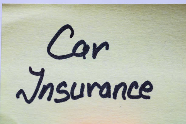 istock Car insurance handwriting text close up isolated on yellow paper with copy space. 1255887234