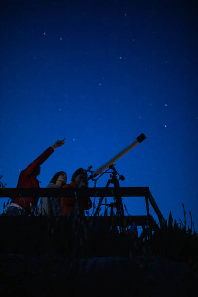 istock Mother and children are watching stars 1255887281