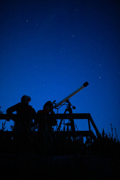 istock Father and son are watching stars 1255887363