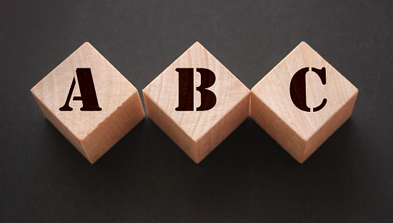 ABC Three wooden cubes with letters. Back to basics elementary school concept.