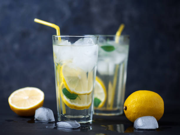 istock A glass of summer lemonade with lemon, mint, ice on a dark concrete table 1255890362