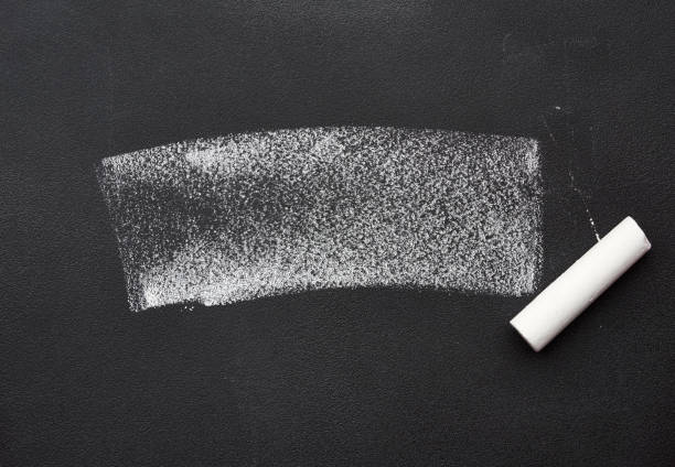 istock white chalk sample on a black chalk board and a piece of chalk 1255890412