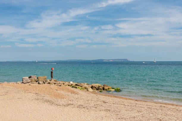 Stone groyne at Hengistbury Head in Dorset Stone groyne at Hengistbury Head in Dorset with the Isle of Wight in the distance hengistbury head photos stock pictures, royalty-free photos & images