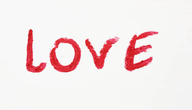 istock love written in red lipstick on a white paper, date concept 1255890575