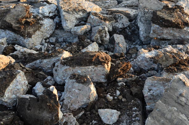 istock Broken pieces of asphalt at a construction site. Recycling and reuse crushed concrete rubble, asphalt, building material, blocks 1255891491