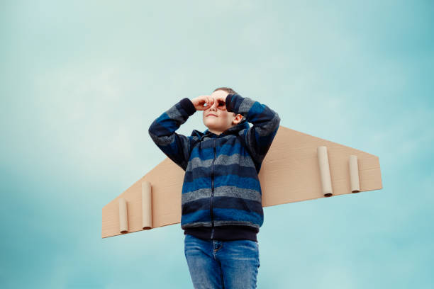 istock Child pilot looks through improvised binoculars into the distance 1255892692