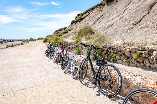 Bournemouth, UK. Sunday 12 July 2020. Bicycles lined up at Hengistbury Head in Bournemouth.