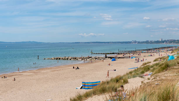 Bournemouth, UK. Sunday 12 July 2020. People enjoy summer on the beach at Hengistbury Head in Dorset near Bournemouth.