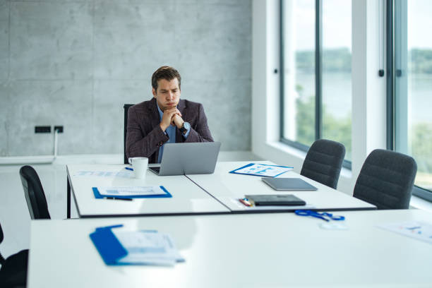 istock Worried businessman reading an e-mail on laptop in the office. 1255896848