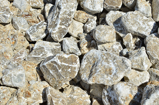 Natural gray gypsum stone. Close up image of stones with black and white. Industrial mining area. Limestone mining, quarry