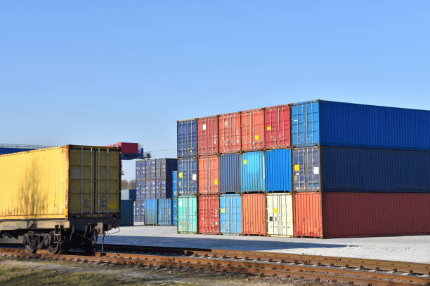 istock International ship container terminal. Cargo sea containers on freight train. 1255900507