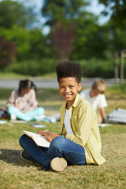 istock Smiling African Boy Enjoying Outdoor School Lesson 1255903480
