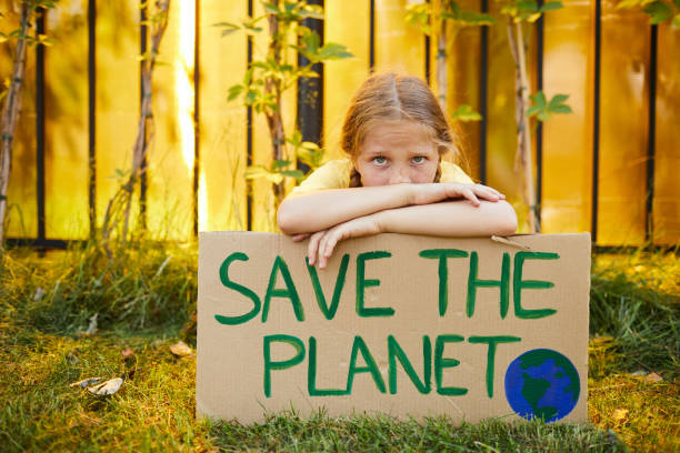 istock Girl Holding Save The Planet Poster 1255903565