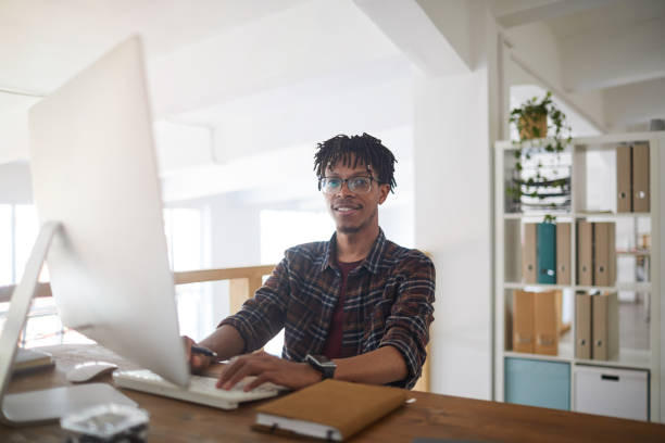istock Young African-American Man Enjoying Work in Office 1255905279