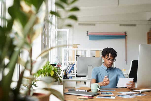 istock African-American Editor at Desk in Publishing Office 1255905322