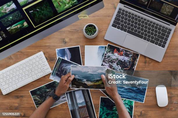 Travel Photographer Holding Pictures Top View Stock Photo - Download Image Now - Photograph, Photography, Printing Out