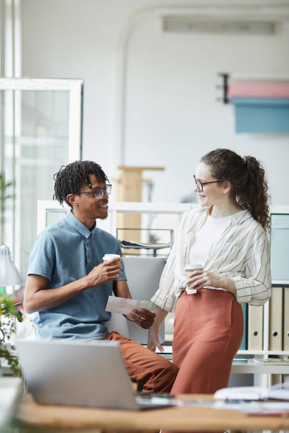 istock Cheerful Young People Chatting at Coffee Break in Office 1255905336