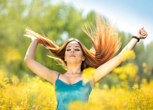 istock Young redhead woman make her hair to fly 1255906796