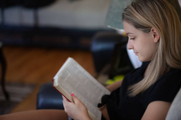 istock Young woman reading a book and enjoying in weekend 1255907114