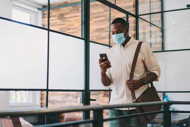 Photo of Safety in the office during COVID-19 pandemic, businessman with face mask
