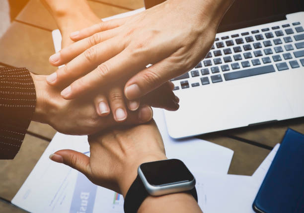 istock Close up of people putting their hands togetherwhich  Collaboration and teamwork concept 1255909917
